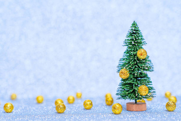 istock Miniature toy christmas tree and balls background 1440315846