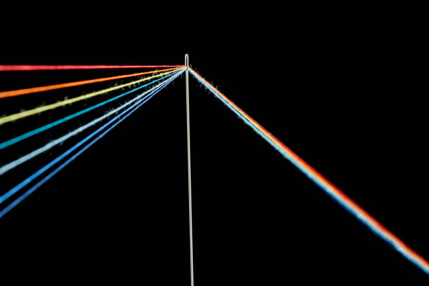 istock multi-colored threads for sewing in the form of a rainbow pass through an antique needle on a black background 1440316970