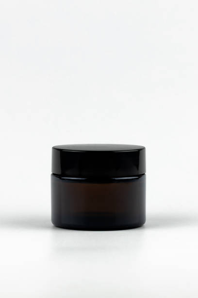istock cosmetic jar on white background. blank label. black or brown unbranded cosmetic jar mock up. branding identity mockup vertical concept 1440319183