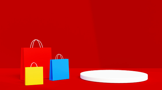Colorful shopping bags with empty product presentation podium platform on the red background with copy space, shopping concepts