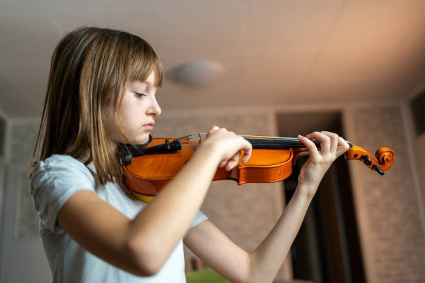 istock Caucasian girl tuning violin 1440324153