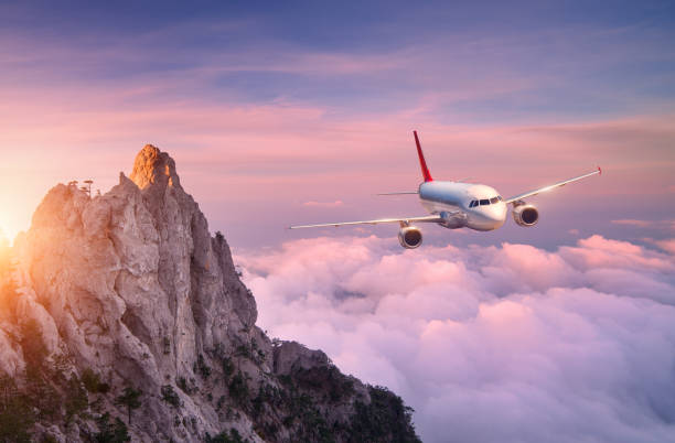 istock Airplane is flying over clouds at sunset. Landscape 1440325189