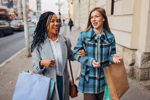 istock Two best friends dressed in casual clothes are walking down the street after shopping 1440327413