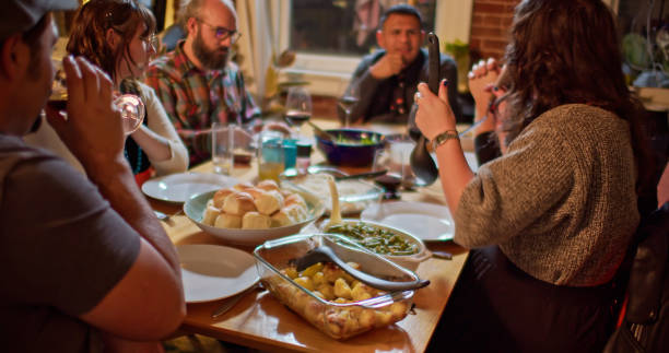 istock Friendsgiving Dinner Guests Serving Food 1440328158