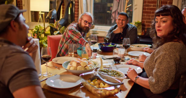 istock Friendsgiving Dinner Guests Serving Food 1440328165