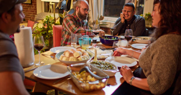 istock Friendsgiving Dinner Guests Gathered Around Table 1440328169
