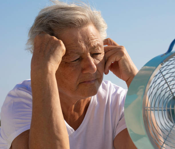 istock Elderly Woman with Fan 1440328176