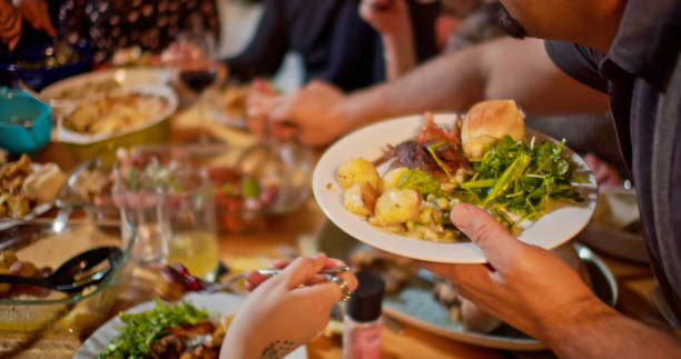 istock Man Serving Himself at Friendsgiving Potluck Dinner 1440328267