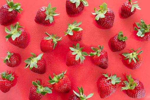 Strawberries on red background.