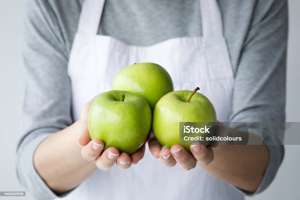 Woman Showing Green Apples Young woman holding green apples. Apple - Fruit Stock Photo