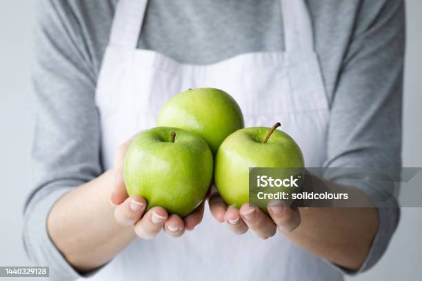 Woman Showing Green Apples Stock Photo - Download Image Now - Apple - Fruit, Green Color, Adult