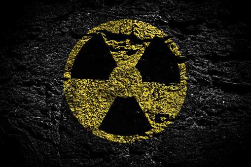 Radiation sign on a black stone background. Copy space. The concept of nuclear confrontation