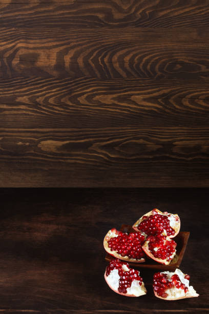 istock ripe peeled pomegranate on a wooden background, pomegranate seeds. with copyspace 1440332163