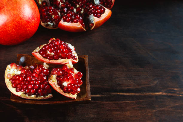 istock ripe peeled pomegranate on a wooden background, pomegranate seeds. with copyspace 1440332175