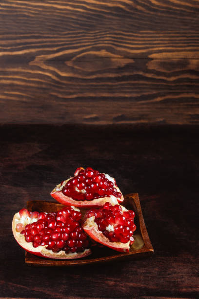 istock ripe peeled pomegranate on a wooden background, pomegranate seeds. with copyspace 1440332200
