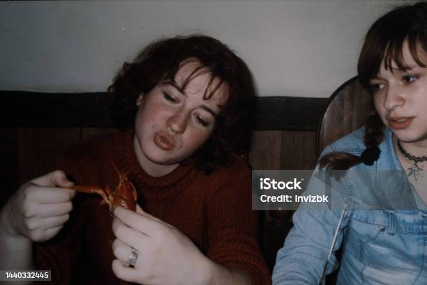 Two Sisters Are Sitting At The Cafe And One Of Them Playing With Cooked Lobster Vintage Photo Stock Photo - Download Image Now
