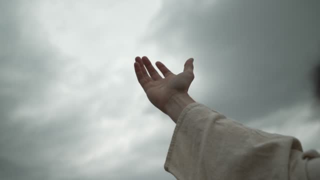 Jesus Or Religious Man Raises Hand To Sky To Pray