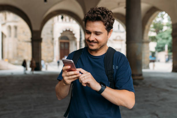 istock Student texting with his smart phone on street 1440334127