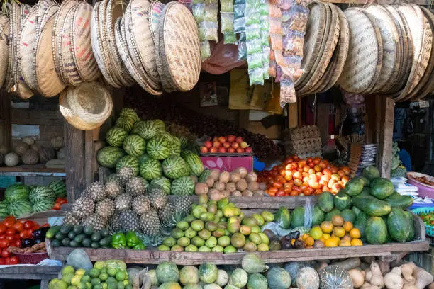 A fruit and vegetable stand in a market in karatu, Tanzania, selling also woven baskets.