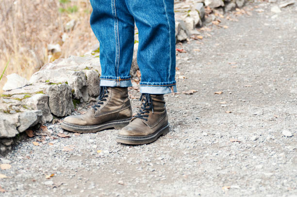 istock Tourist feet in boots on a mountain path 1440335884
