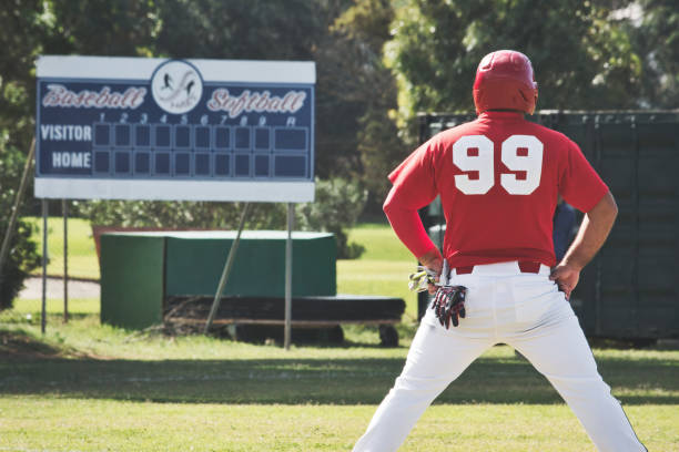 istock A baseball player on the pitch standing with his back towards the camera with an empty scoreboard in the background 1440336487