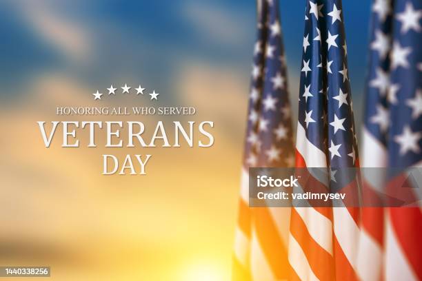 American Flags With Text Veterans Day Honoring All Who Served On Sunset Background Stock Photo - Download Image Now