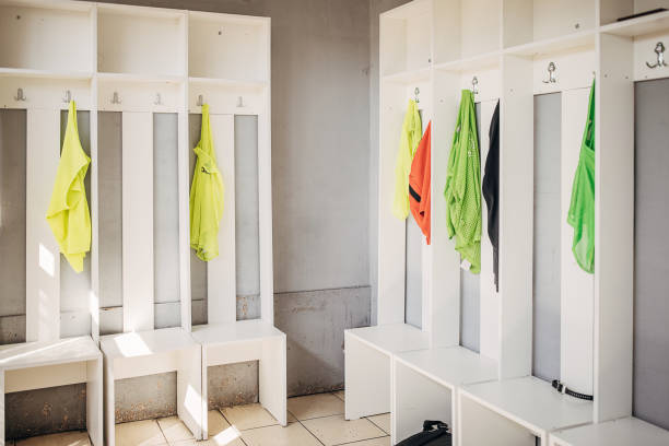 Jerseys hanging in empty sports dressing room.