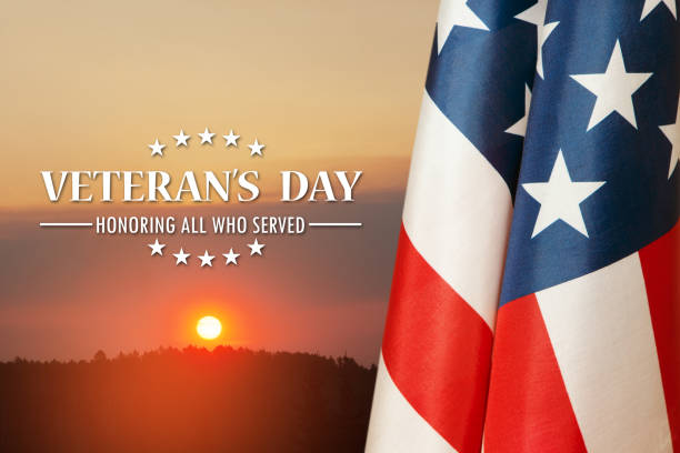 istock American flags with Text Veterans Day Honoring All Who Served on sunset background. 1440338294