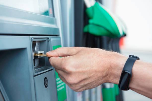 Person paying with credit card at a gas station stock photo