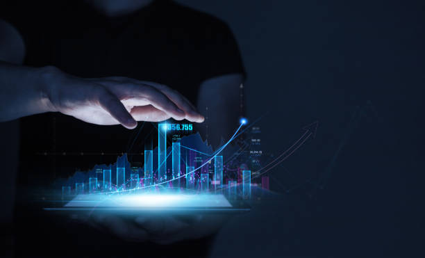 istock Businessman holding tablet with growing virtual hologram of statistics, graph and chart. Business strategy development and planning investment. 1440342240