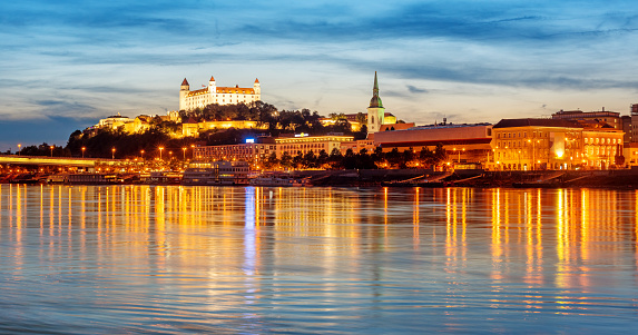 Panoramic view of the Bratislava Old town reflecting in Danube river on sunset, Slovakia