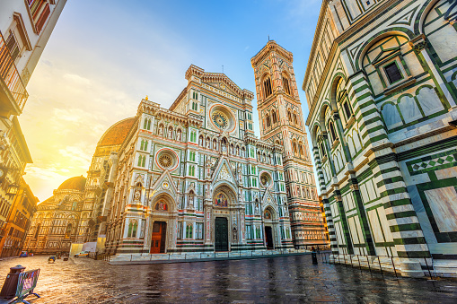 Cathedral of Santa Maria del Fiore with Brunelleschi's Dome, Giotto's Campanile and Baptisterium in Piazza del Duomo, Florence, Italy, in dramatic sunrise light