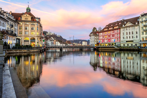 Historical Old town of Lucerne, Switzerland, reflecting in Reuss river on dramatic sunrise