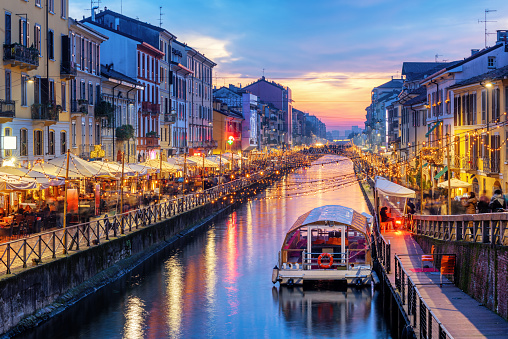 Naviglio Grande canal in Milan city, Italy, a popular tourist area, on dramatic sunset