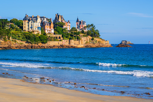 Sand beach and historical villas in Dinard, Brittany, France. Dinard is a popular seaside resort on the french Atlantic ocean coast.