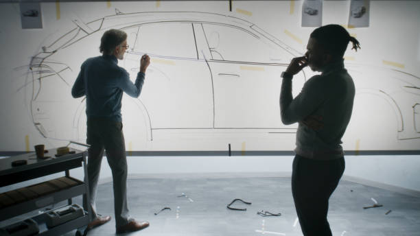 istock Designers drawing sketch of future car 1440347030