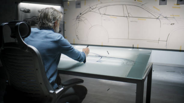 istock Designer drawing future car sketch in studio 1440347099