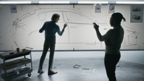 istock Designers drawing sketch of future car 1440348015
