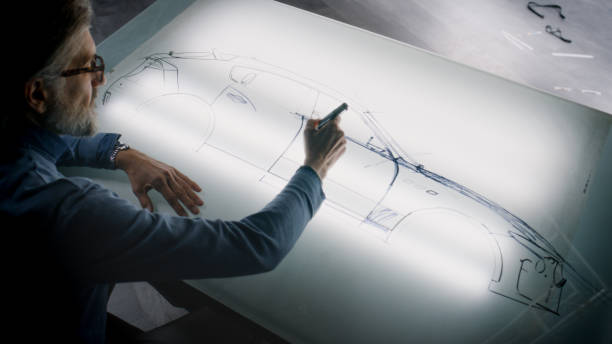 istock Senior designer drawing new car sketch with marker 1440348220