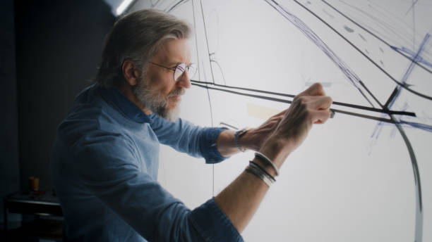 istock Designer creating car sketch with duct tape 1440349912