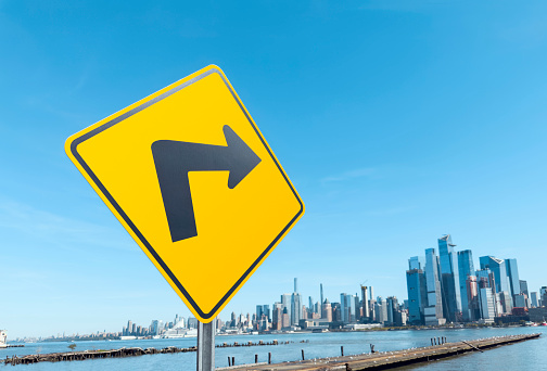 Road sign with Right turn arrow showing New York City