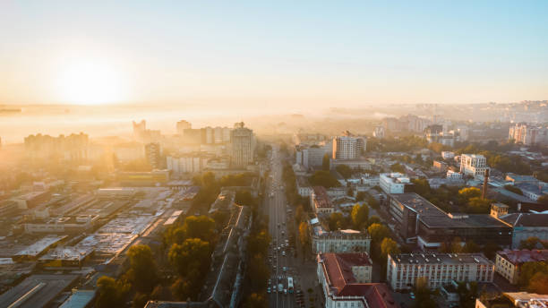 Aerial drone view of Chisinau at sunrise, Moldova Aerial drone view of Chisinau at sunrise, Moldova. View of city centre covered with fog, multiple buildings, Bright Sun moldova stock pictures, royalty-free photos & images