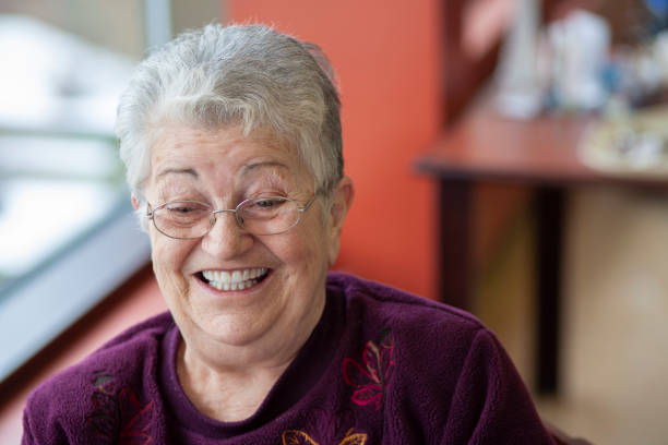 istock Cheerful elderly woman looking at camera smiling, and laughing. 1440358588