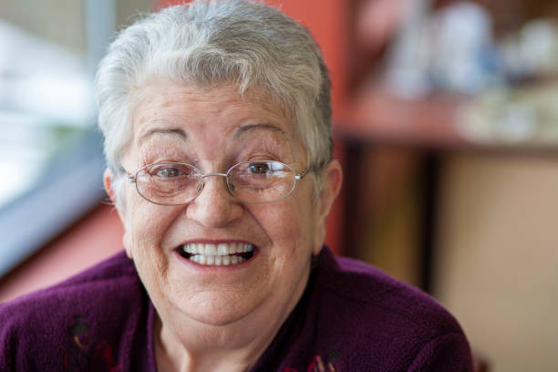 istock Cheerful elderly woman looking at camera smiling, and laughing. 1440358589