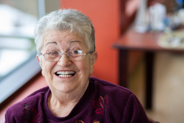 istock Cheerful elderly woman looking at camera smiling, and laughing. 1440358590