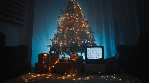 Christmas tree in a house with sofas and white carpet.