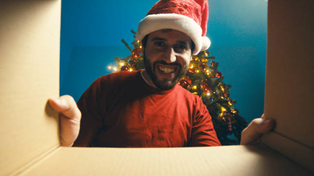 istock Boy is closing the Christmas gift box under the tree 1440358803