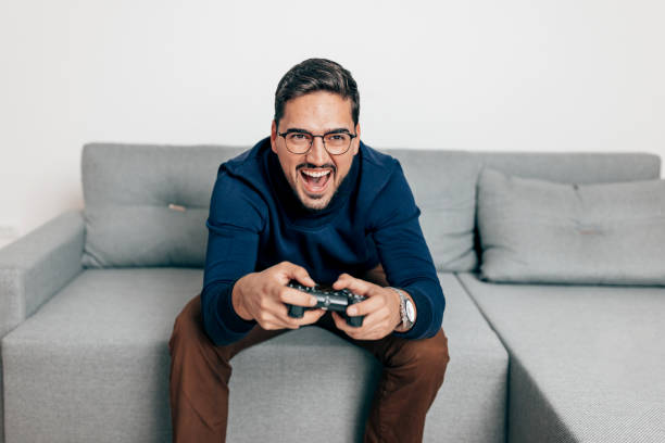 istock Man with joystick playing video games 1440359464