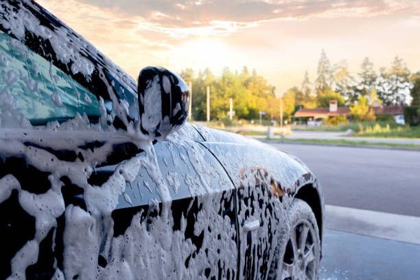 istock Car wash. Close-up car is in the active foam. 1440360302