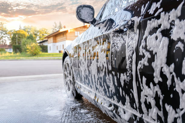 istock Washing black car with active foam 1440360322